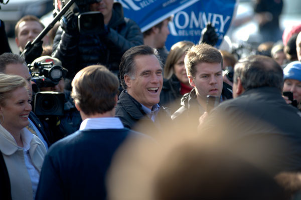 The media swarm Mitt Romney at a polling place.